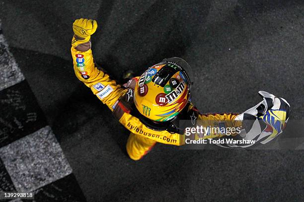 Kyle Busch, driver of the M&M's Brown Toyota, celebrates with the checkered flag after winning the NASCAR Budweiser Shootout at Daytona International...