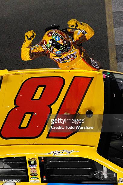 Kyle Busch, driver of the M&M's Brown Toyota, celebrates after winning the NASCAR Budweiser Shootout at Daytona International Speedway on February...