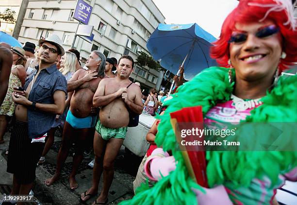 Brazilian revelers watch Carnival celebrations along Ipanema beach on February 18, 2012 in Rio de Janiero, Brazil. Carnival is the grandest holiday...