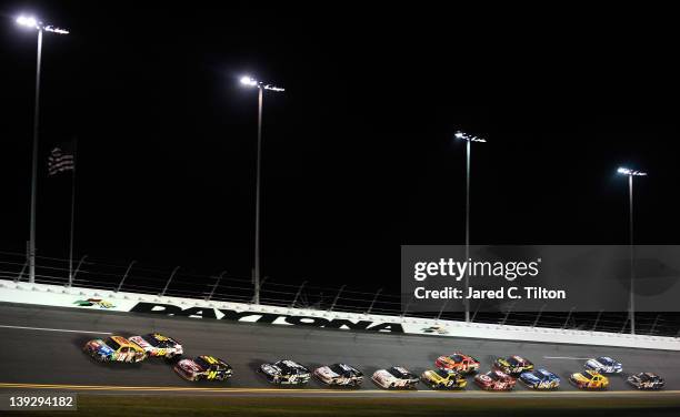 Kyle Busch, driver of the M&M's Brown Toyota, leads a pack during the NASCAR Budweiser Shootout at Daytona International Speedway on February 18,...