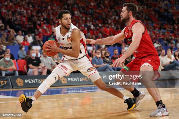 Tyler Harvey of the Hawks controls the ball against Mitch Norton of the Wildcats during the round 21 NBL match between the Perth Wildcats and...