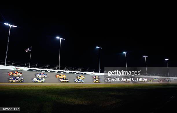 Martin Truex Jr., driver of the NAPA Auto Parts Toyota and Jamie McMurray, driver of the Bass Pro Shops/Tracker Boats Chevrolet, lead a group of cars...