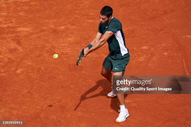 Carlos Alcaraz of Spain returns a ball to Jaume Munar of Spain during day five of the Barcelona Open Banc Sabadell at Real Club De Tenis Barcelona on...