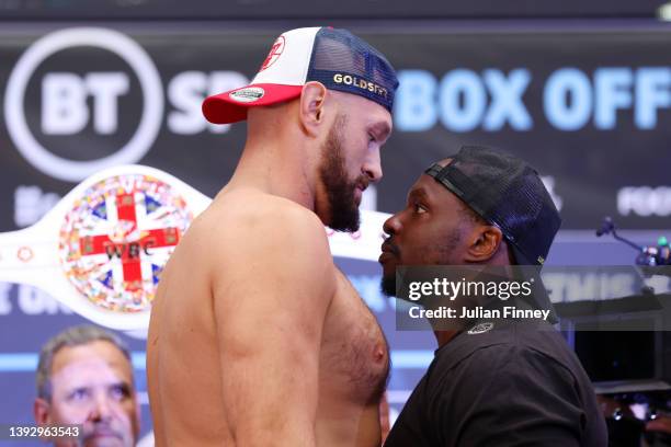 Tyson Fury of Great Britain and Dillian Whyte of Great Britain face-off as the custom 'Union Belt' is displayed behind them during the weigh-in ahead...