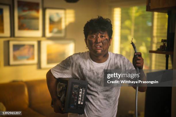 domestic accidents and electricity dangers. - burnt man stock pictures, royalty-free photos & images