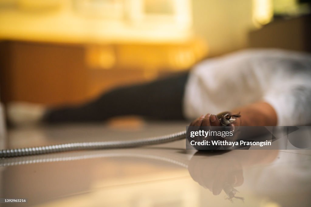 Man electrocuted, lying injured on a household floor