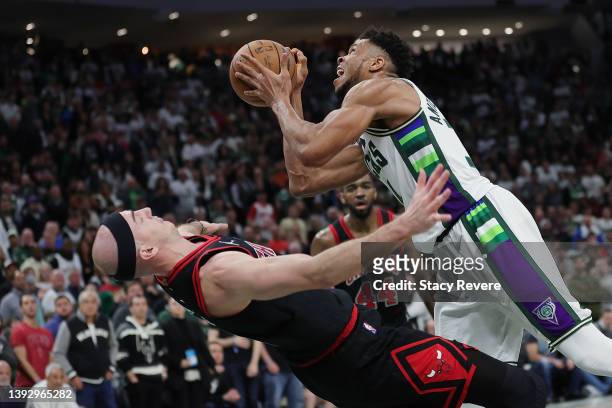 Alex Caruso of the Chicago Bulls is fouled by Giannis Antetokounmpo of the Milwaukee Bucks during Game Two of the Eastern Conference First Round...