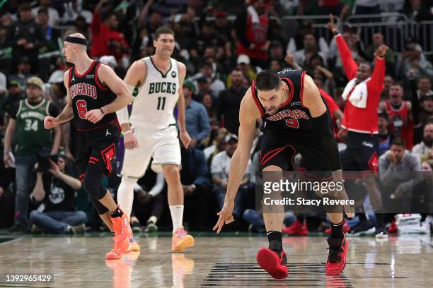 Nikola Vucevic of the Chicago Bulls reacts to a three point shot against the Milwaukee Bucks during Game Two of the Eastern Conference First Round...