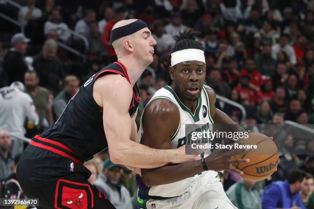 Jrue Holiday of the Milwaukee Bucks is defended by Alex Caruso of the Chicago Bulls during Game Two of the Eastern Conference First Round Playoffs at...