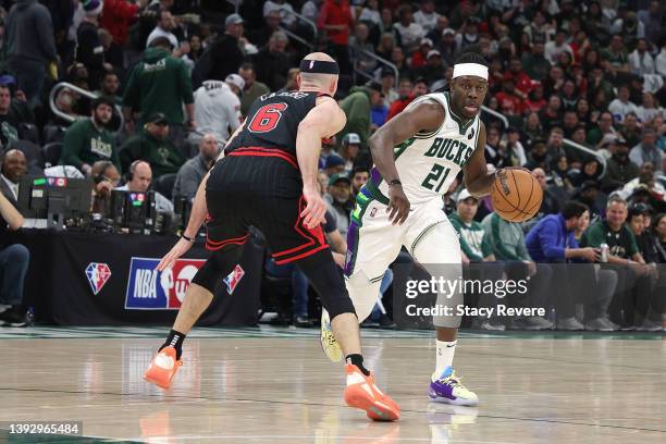 Jrue Holiday of the Milwaukee Bucks is defended by Alex Caruso of the Chicago Bulls during Game Two of the Eastern Conference First Round Playoffs at...