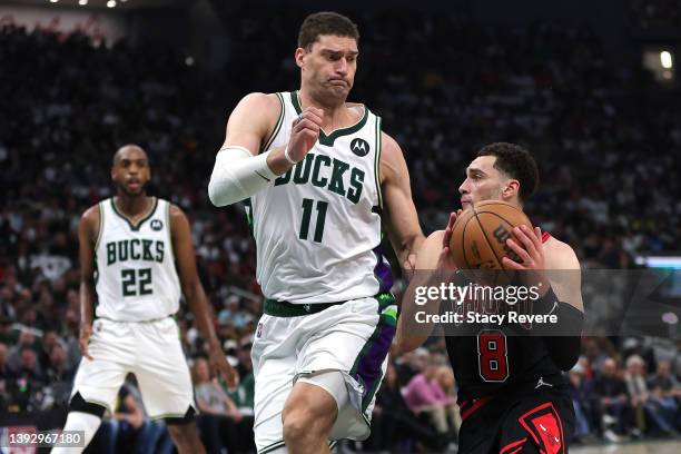 Zach LaVine of the Chicago Bulls is defended by Brook Lopez of the Milwaukee Bucks during Game Two of the Eastern Conference First Round Playoffs at...