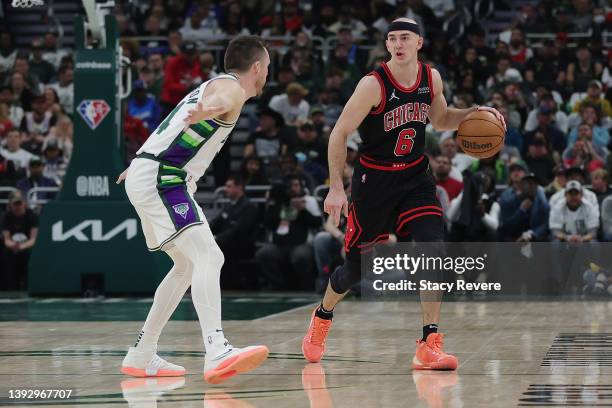 Alex Caruso of the Chicago Bulls is defended by Pat Connaughton of the Milwaukee Bucks during Game Two of the Eastern Conference First Round Playoffs...