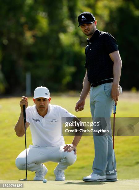 Camilo Villegas of Colombia and Kyle Stanley prepare to putt on the tenth green during the second round of the Zurich Classic of New Orleans at TPC...