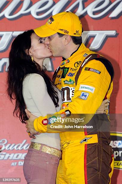 Kyle Busch , driver of the M&M's Brown Toyota, kisses his wife Samantha Busch in Victory Lane after winning the NASCAR Budweiser Shootout at Daytona...