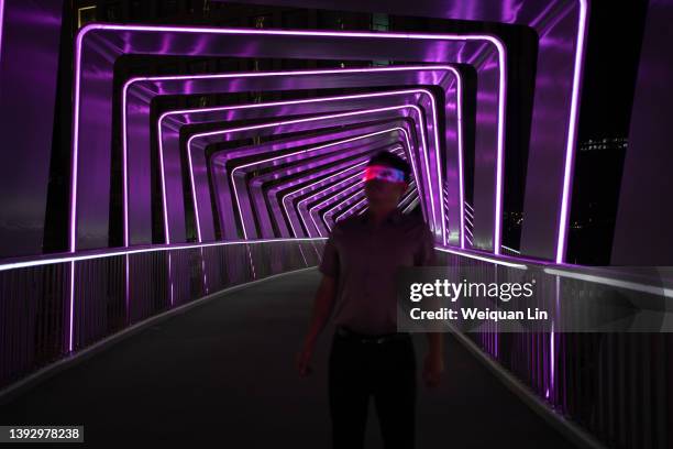 asian man is using smart glasses, metaverse concept - colour enhanced stock pictures, royalty-free photos & images