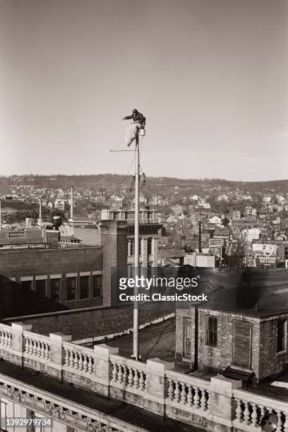 1920s 1930s Man Sitting On Flagpole A Fad Begun In 1924.