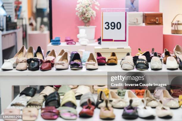 shoes on rack in retail store - shoe shop stock pictures, royalty-free photos & images