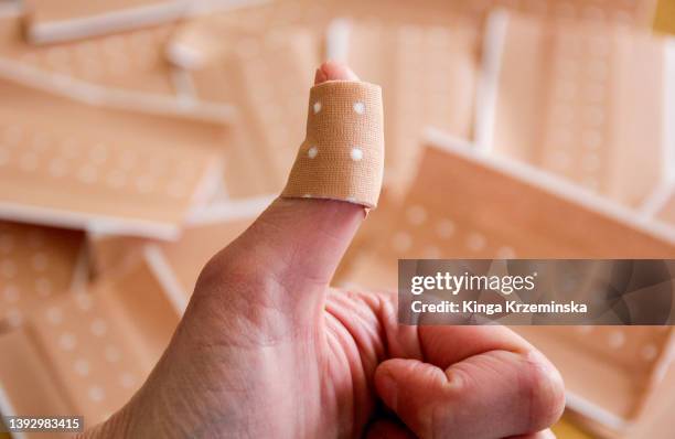 plasters - bandaged thumb stock pictures, royalty-free photos & images