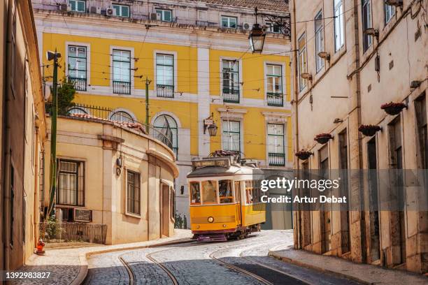 the yellow tram in the barrio alto district of lisbon. - lissabon stockfoto's en -beelden