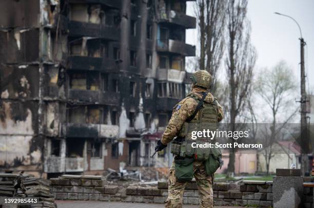 Ukrainian security forces stand guard with shell-damaged buildings in the background, Prime Minister Mette Frederiksen of Denmark and Prime Minister...