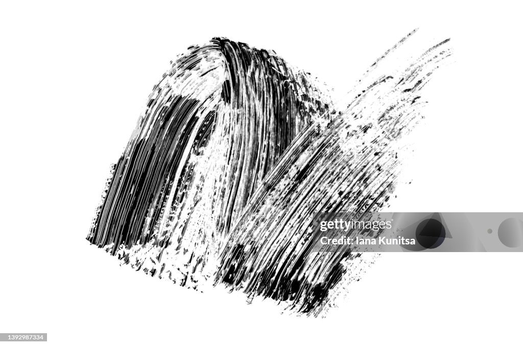 Black smear mascara on white background. Isolated. Makeup. Cosmetic products for eyelashes. Closeup. Beautiful pattern for design.