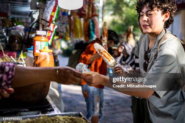 young woman buying food - mexican street market stock pictures, royalty-free photos & images