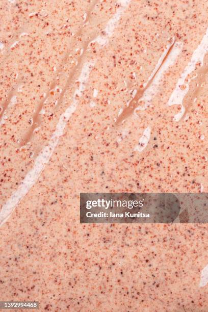 skin care. coffee anti-cellulite body scrub is smeared on beige background. exfoliation. vertical. - hautpeeling stock-fotos und bilder