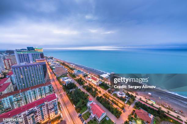 aerial view of modern city on black sea at evening dawn - boulevard foto e immagini stock