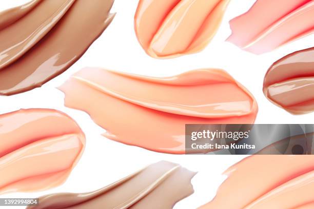 beautiful smears of tone foundation for different skin colors on white background. isolated. cosmetic products for makeup and skin care. - maquillaje de teatro fotografías e imágenes de stock
