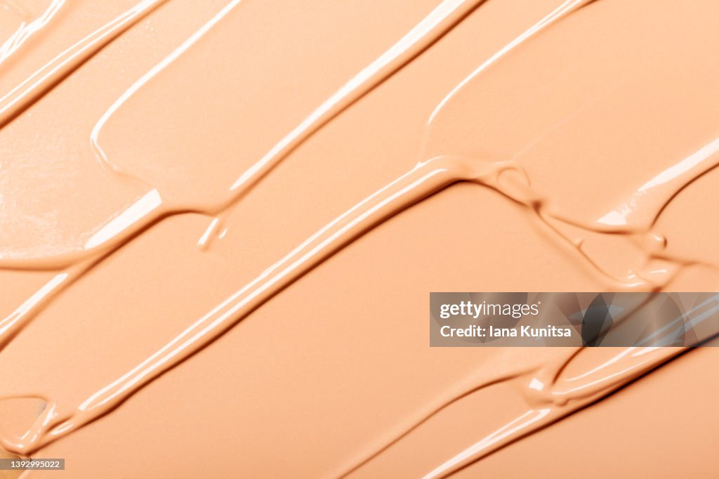 Beautiful delicate beige smeared texture of BB face cream. Tonal Foundation is smudged. Cosmetics products for makeup and skin care. Moisturizing cream. Skin tone.