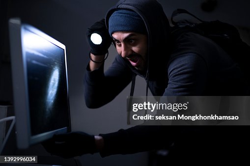 Male Criminal Stealing Computer High-Res Stock Photo - Getty Images