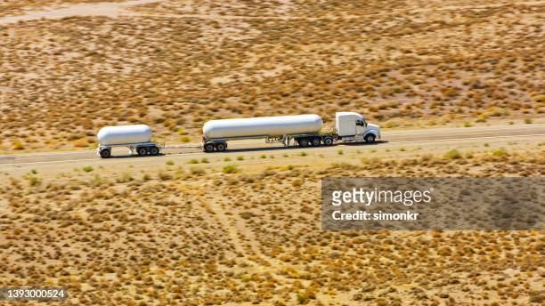 tank truck driving on freeway desert - gas truck stock pictures, royalty-free photos & images
