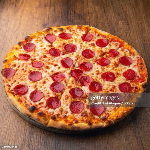 pizza,high angle view of pizza on table - pepperoni pizza stock pictures, royalty-free photos & images