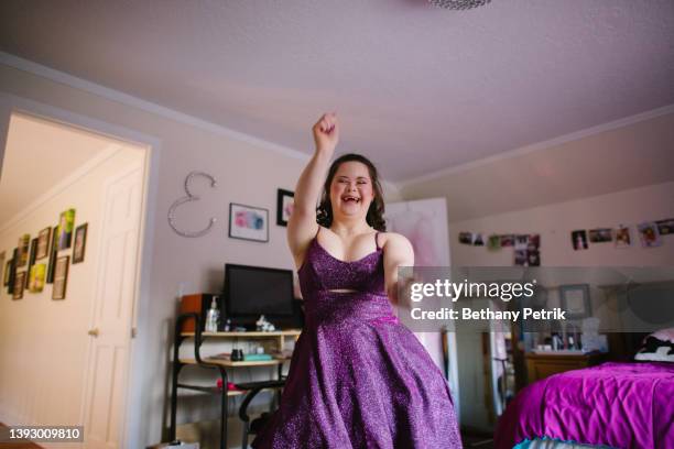 teenage girl dancing in her prom dress - disabilitycollection stockfoto's en -beelden