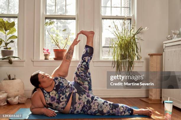 lgbtq+ woman does yoga - showus yoga stock pictures, royalty-free photos & images