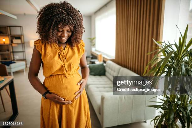 beautiful woman in pregnant at home - prenatal care stockfoto's en -beelden