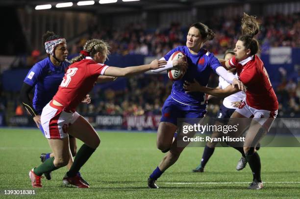 Jessy Tremouliere of France scores their side's fifth try whilst under pressure Hannah Jones and Robyn Wilkins of Wales during the TikTok Women's Six...