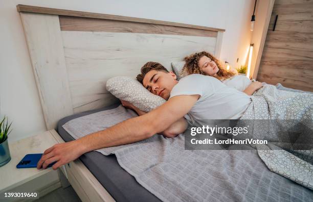 man in bed taking the phone - overslept stock pictures, royalty-free photos & images