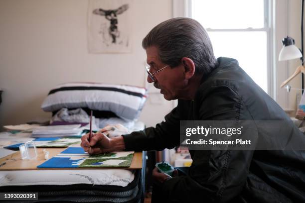 Arnie Raimondo, who was recently released from prison after 40 years, paints in his Rockaway home where he lives with other veterans on April 22,...