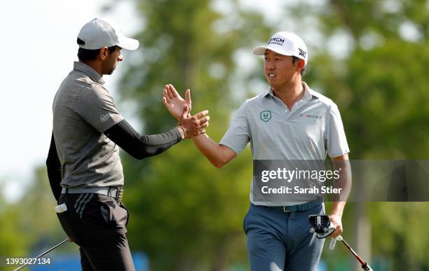 David Lipsky and Aaron Rai of England react to a birdie putt on the 18th green during the second round of the Zurich Classic of New Orleans at TPC...