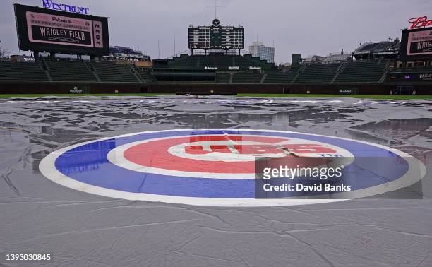 Rain soaked tarp sits on the field before a game between the Chicago Cubs and the Pittsburgh Pirates at Wrigley Field on April 22, 2022 in Chicago,...