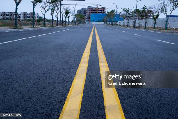 asphalt pavement under cloudy sky - asphalt paver stock pictures, royalty-free photos & images