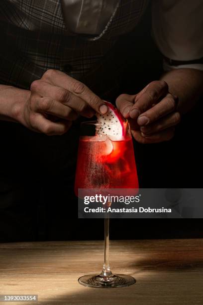 bartender decorating tropical cocktail. - garnish stock pictures, royalty-free photos & images