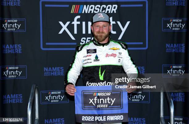 Jeffrey Earnhardt, driver of the ForeverLawn Chevrolet, poses for photos after winning the pole award during qualifying for the NASCAR Xfinity Series...