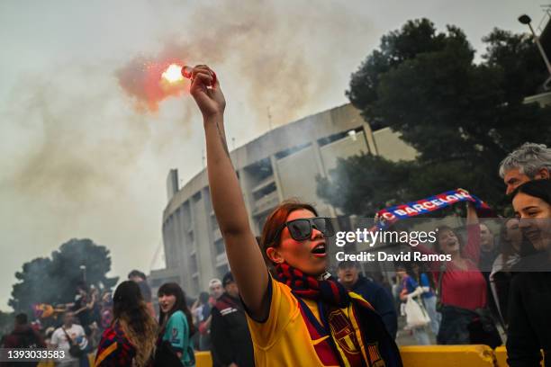 Barcelona supporter lights a flare as she shows her support outside the stadium prior to the UEFA Women's Champions League Semi Final First Leg match...