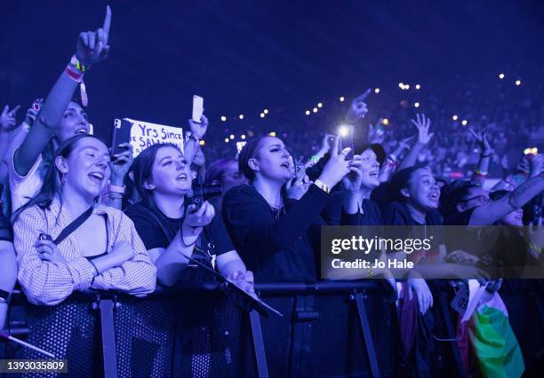 Fans watch Louis Tomlinson perform on stage at the OVO Arena Wembley on April 22, 2022 in London, England.