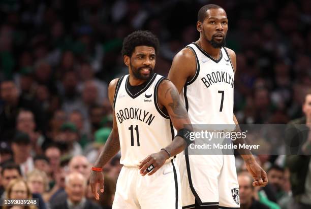 Kyrie Irving of the Brooklyn Nets and Kevin Durant look on during the first quarter of Round 1 Game 1 of the 2022 NBA Eastern Conference Playoffs...