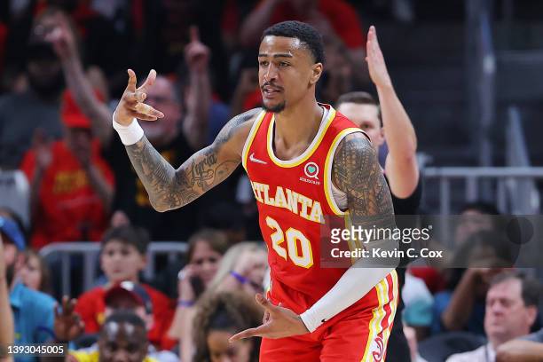 John Collins of the Atlanta Hawks celebrates a three pointer against the Miami Heat during the second quarter in Game Three of the Eastern Conference...