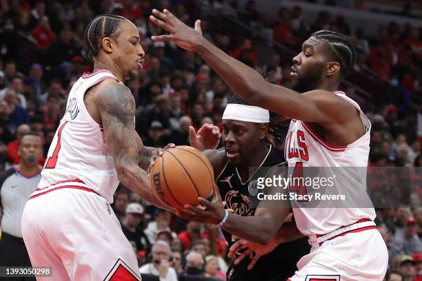 Jrue Holiday of the Milwaukee Bucks drives between DeMar DeRozan and Patrick Williams of the Chicago Bulls during the second quarter of Game Three of...