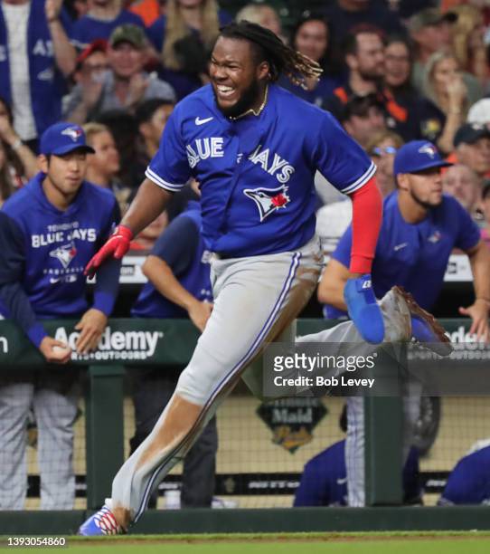 Vladimir Guerrero Jr. #27 of the Toronto Blue Jays scores on a Matt Chapman double in the ninth inning against the Houston Astros at Minute Maid Park...